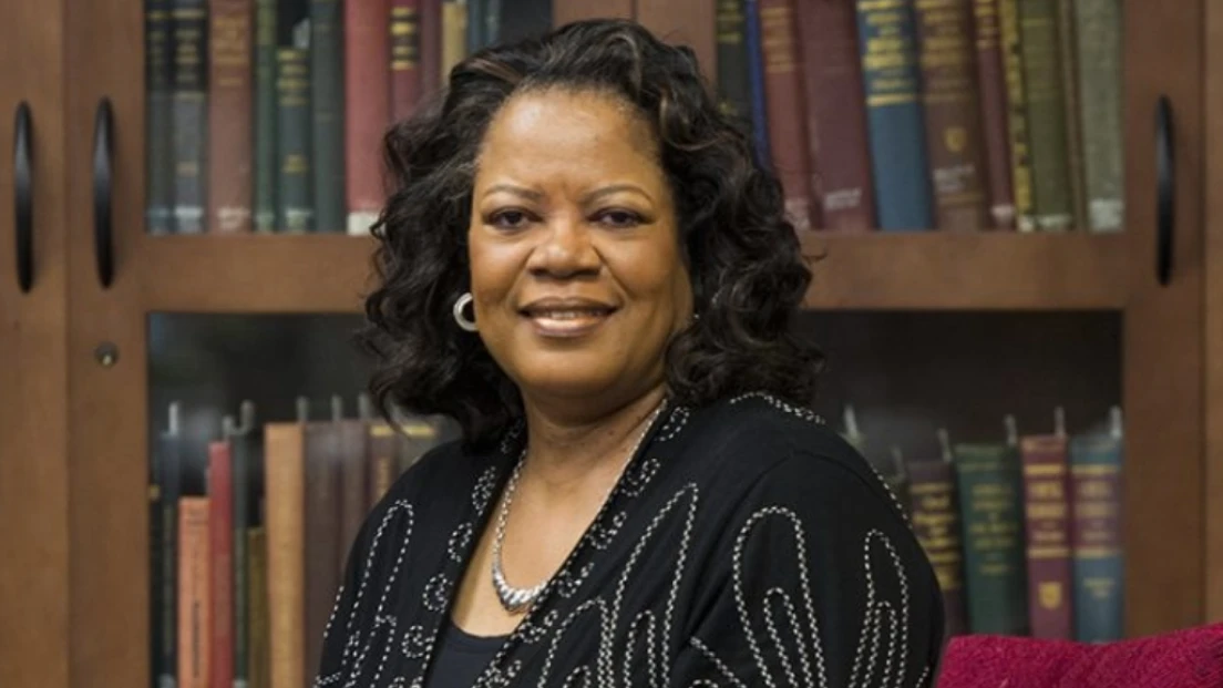 Dr. Laverne Holyfield in a feature photo in front of dental medicine textbooks.
