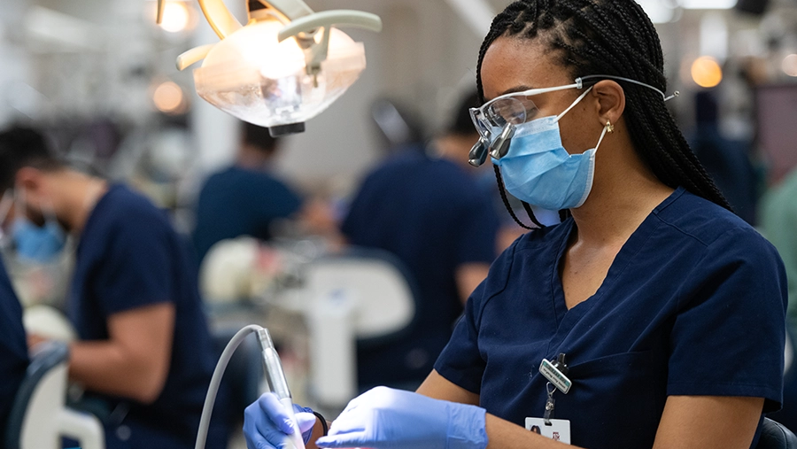 Dental student working in simulation laboratory.