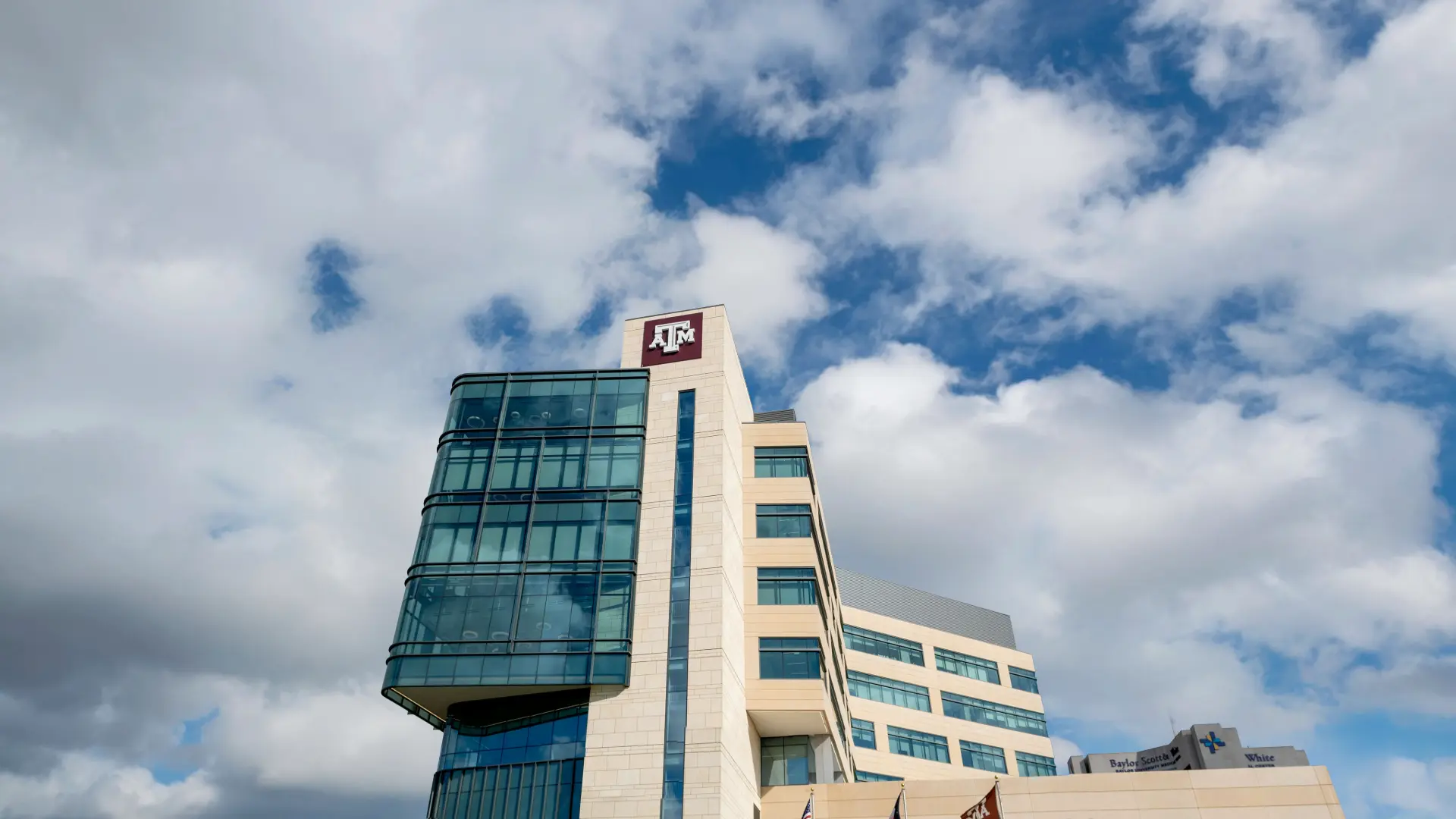 Dentistry clinic building on a background with a cloud-filled sky.